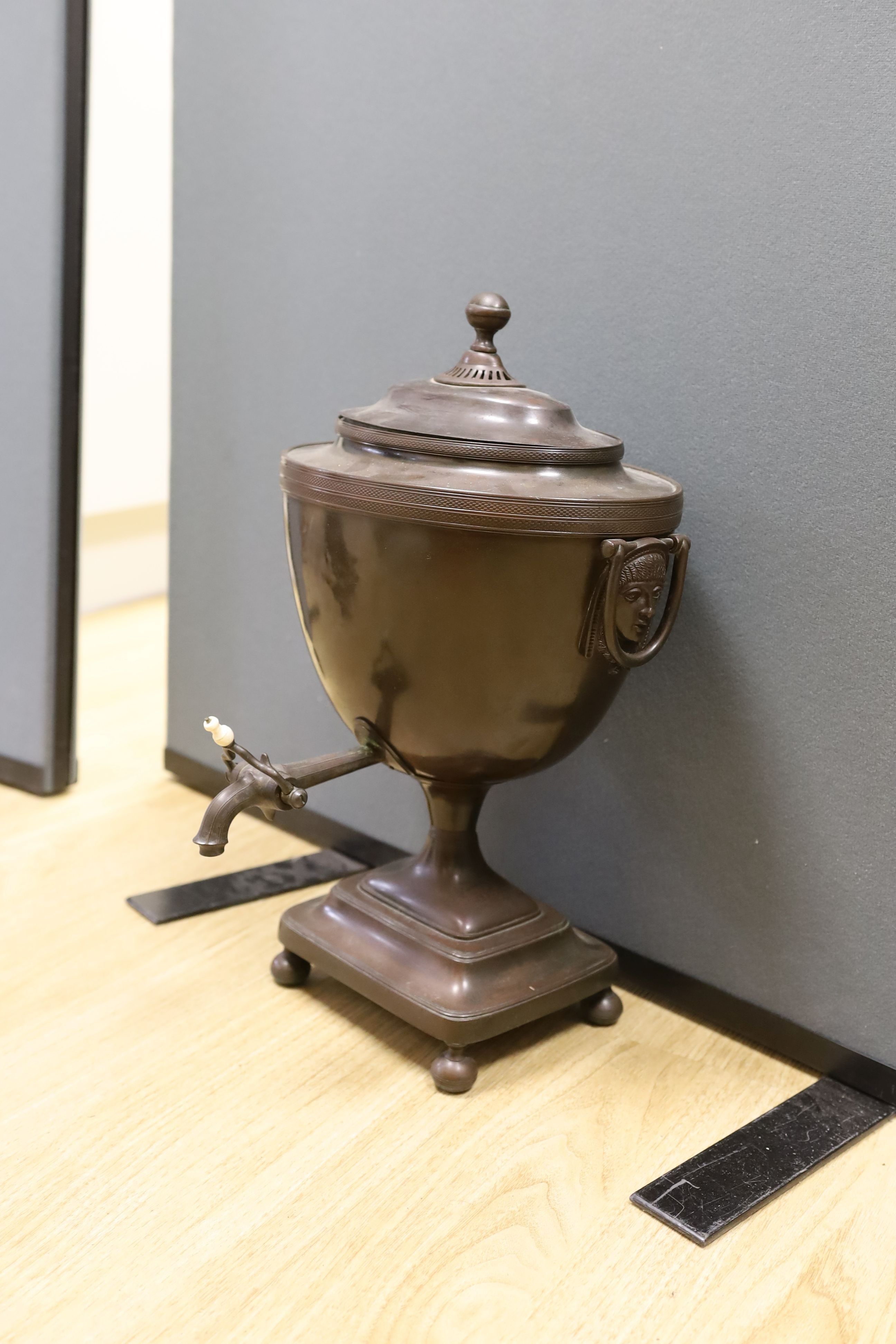 After Alex Decaix - A Regency copper tea urn, with classical caryatid mask and ring handles, 48 cms high.